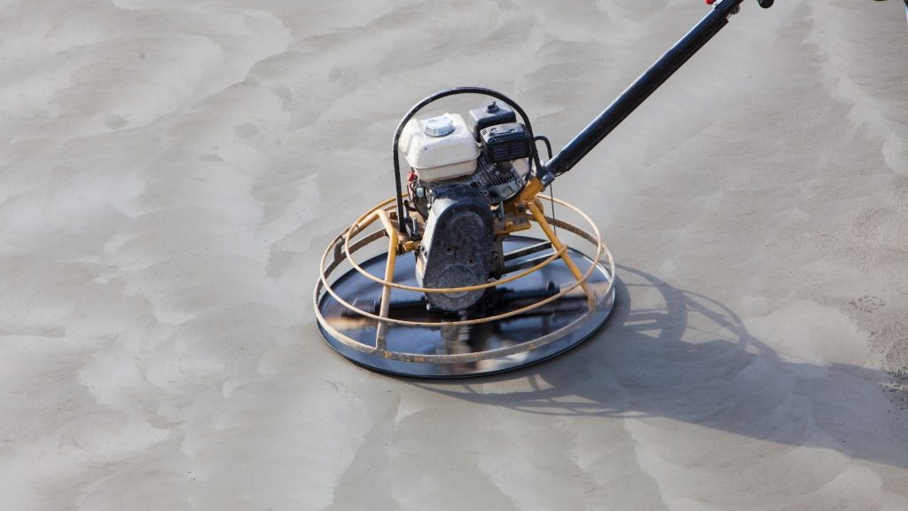 concrete polishing machine over a concrete slab